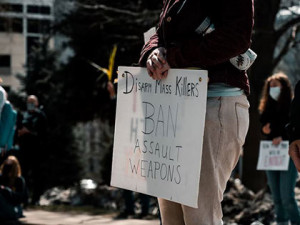 Demoplakat: strengere Waffengesetze sind der Politik zu wenig (Foto: unsplash.com, Colin Lloyd)